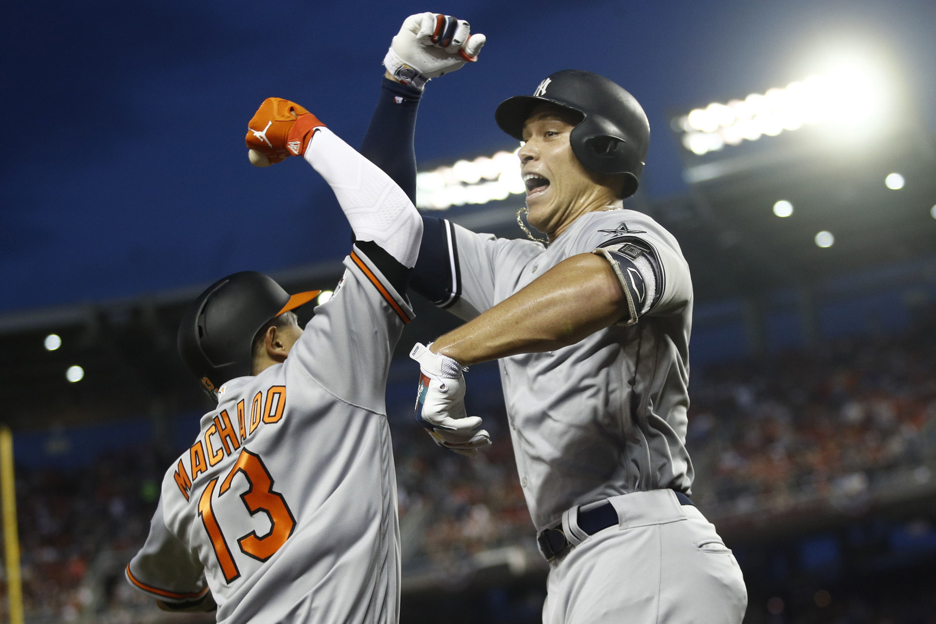 New York Yankees outfielder Aaron Judge (99) celebrates his solo home run with Baltimore Orioles shortstop Manny Machado (13) during the first inning Major League Baseball All-star Game, Tuesday, July 17, 2018 in Washington. (AP Photo/Patrick Semansky)