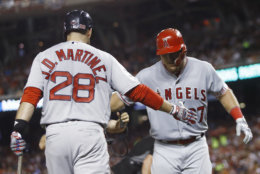 Los Angeles Angels of Anaheim outfielder Mike Trout (27) is welcomed at the dugout by Boston Red Sox's J.D. Martinez (28) after his solo home run during the third inning of the Major League Baseball All-Star Game, Tuesday, July 17, 2018, in Washington. (AP Photo/Patrick Semansky)