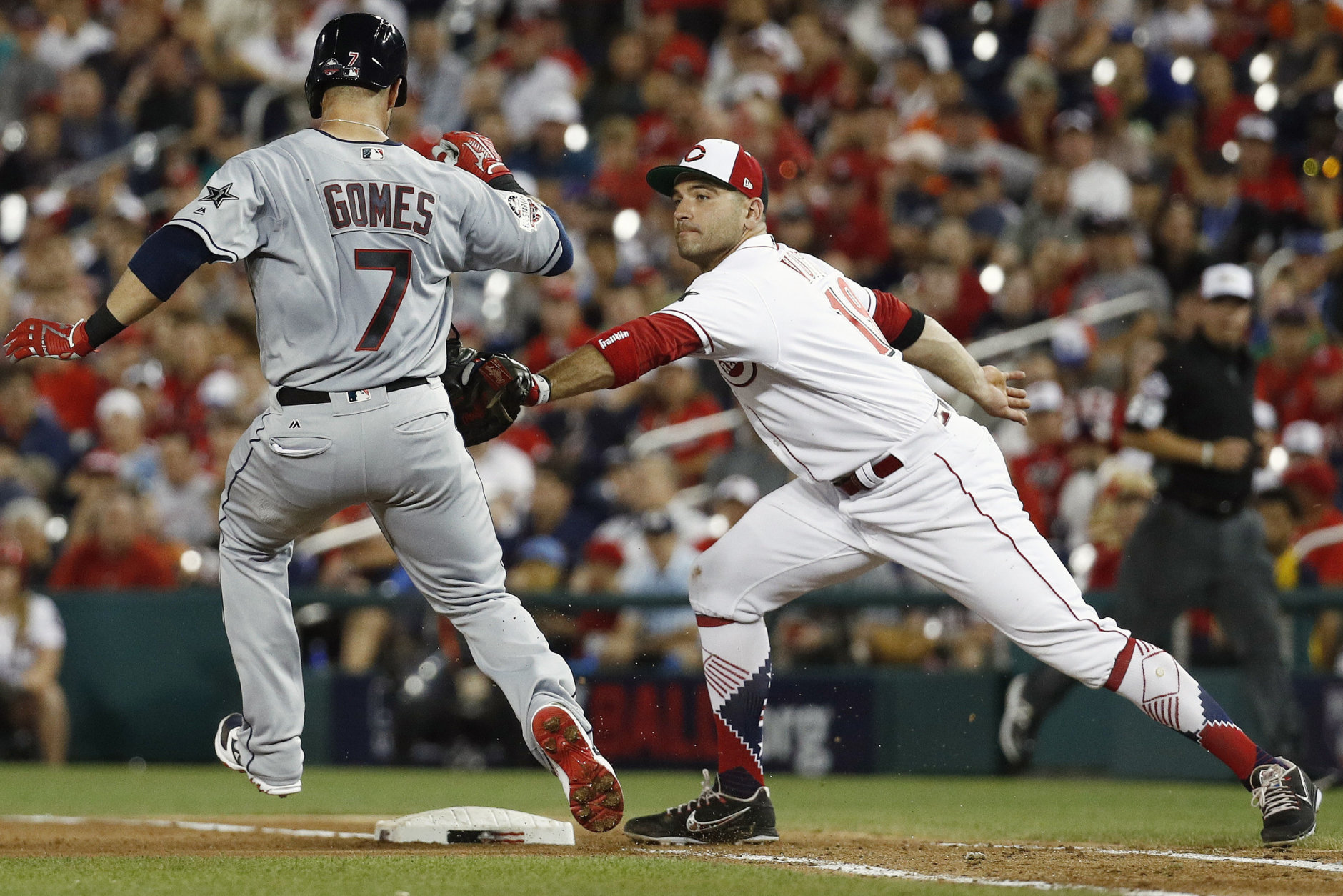 Cincinnati Reds first baseman Joey Votto (19) takes out Cleveland Indians Yan Gomes (7) during the seventh inning at the Major League Baseball All-star Game, Tuesday, July 17, 2018 in Washington. (AP Photo/Patrick Semansky)