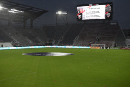 A sign on the scoreboard tells of severe weather which delayed the start of the MLS soccer match between D.C. United and the New York Red Bulls, Wednesday, July 25, 2018, in Washington. (AP Photo/Nick Wass)