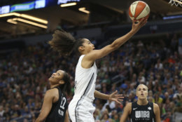Team Candace Parker's Skylar Diggins-Smith, center, goes to the basket against Team Delle Donne's A'ja Wilson (22) in the first half of the WNBA All-Star basketball game Saturday, July 28, 2018 in Minneapolis. (AP Photo/Stacy Bengs)
