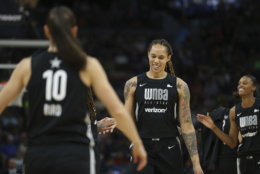 Team Delle Donne's Brittney Griner, middle, smiles as she high-fives teammate Seimone Augustus in the first half of the WNBA All-Star basketball game against Team Candace Parker, Saturday, July 28, 2018 in Minneapolis. (AP Photo/Stacy Bengs)
