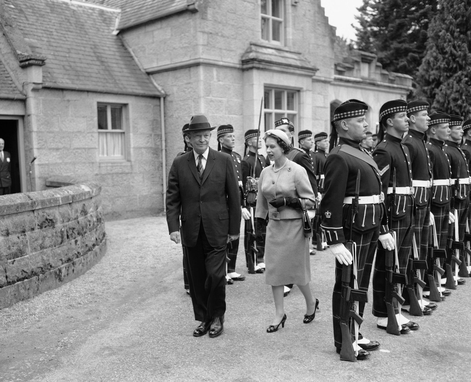 Queen Elizabeth escorts visiting President Dwight D. Eisenhower as they review the Royal Bodyguard, the Royal Highland Fusiliers, at the gates of Balmoral Castle in Scotland, Aug. 28, 1959. The president flew from London to be the Queen's guest. (AP Photo)