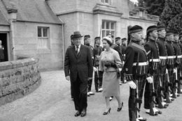Queen Elizabeth escorts visiting President Dwight D. Eisenhower as they review the Royal Bodyguard, the Royal Highland Fusiliers, at the gates of Balmoral Castle in Scotland, Aug. 28, 1959. The president flew from London to be the Queen's guest. (AP Photo)