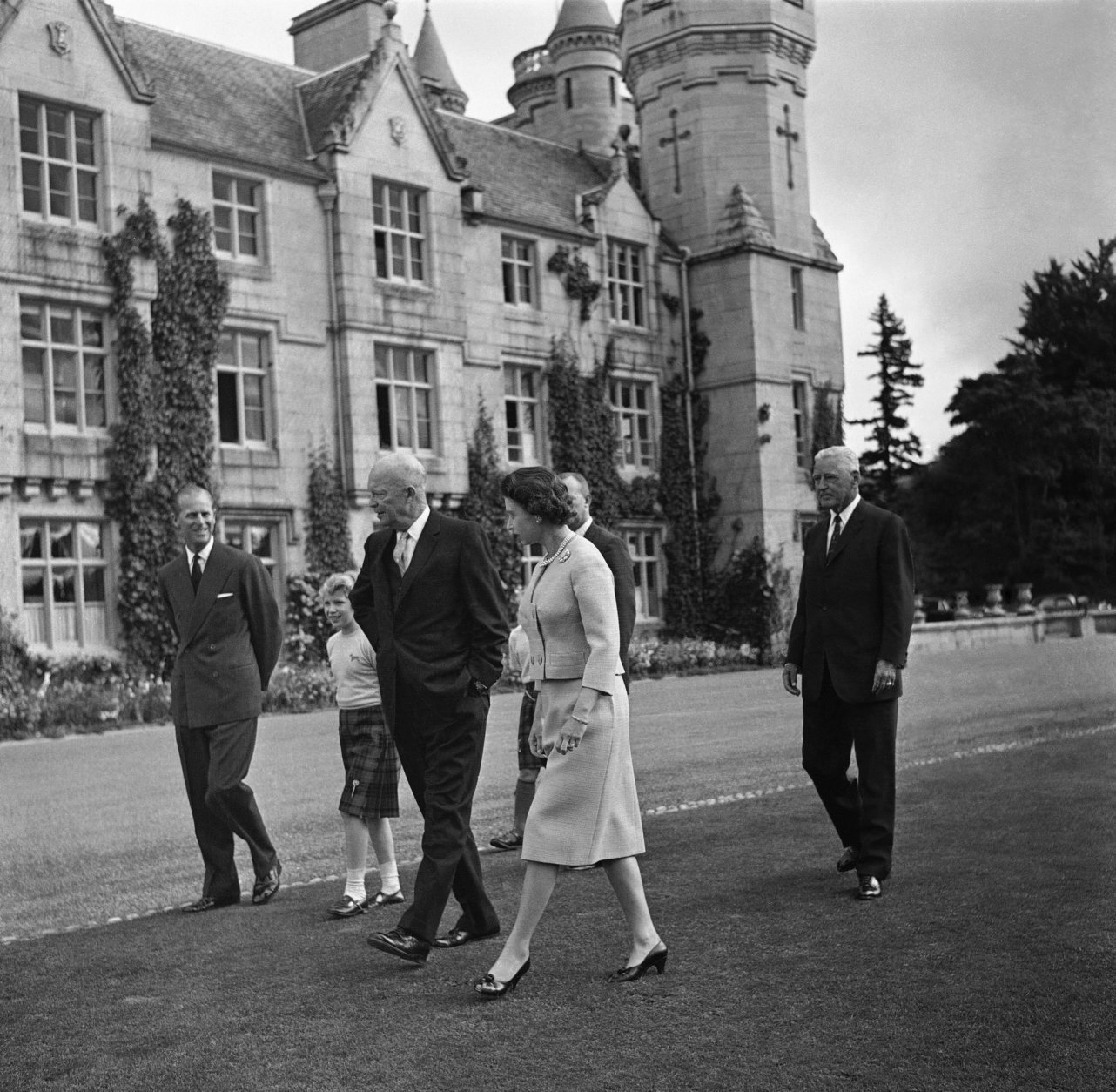 President Dwight D. Eisenhower chats with Prince Philip, Princess Anne and Queen Elizabeth II as they stroll through the grounds of Balmoral Castle in Scotland, Aug. 29, 1959, before the president left for Chequers to meet Prime Minister MacMillan. Eisenhower was an overnight guest at the castle. (AP Photo)