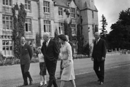President Dwight D. Eisenhower chats with Prince Philip, Princess Anne and Queen Elizabeth II as they stroll through the grounds of Balmoral Castle in Scotland, Aug. 29, 1959, before the president left for Chequers to meet Prime Minister MacMillan. Eisenhower was an overnight guest at the castle. (AP Photo)