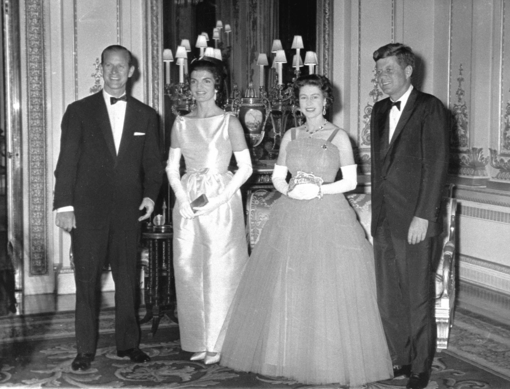 Britain's Queen Elizabeth II poses with U.S. President John F. Kennedy, before a state dinner at Buckingham Palace, June 5, 1961. Also seen are the Duke of Edinburgh, left, and President Kennedy's wife Jackie, second left. (AP Photo/Pool)