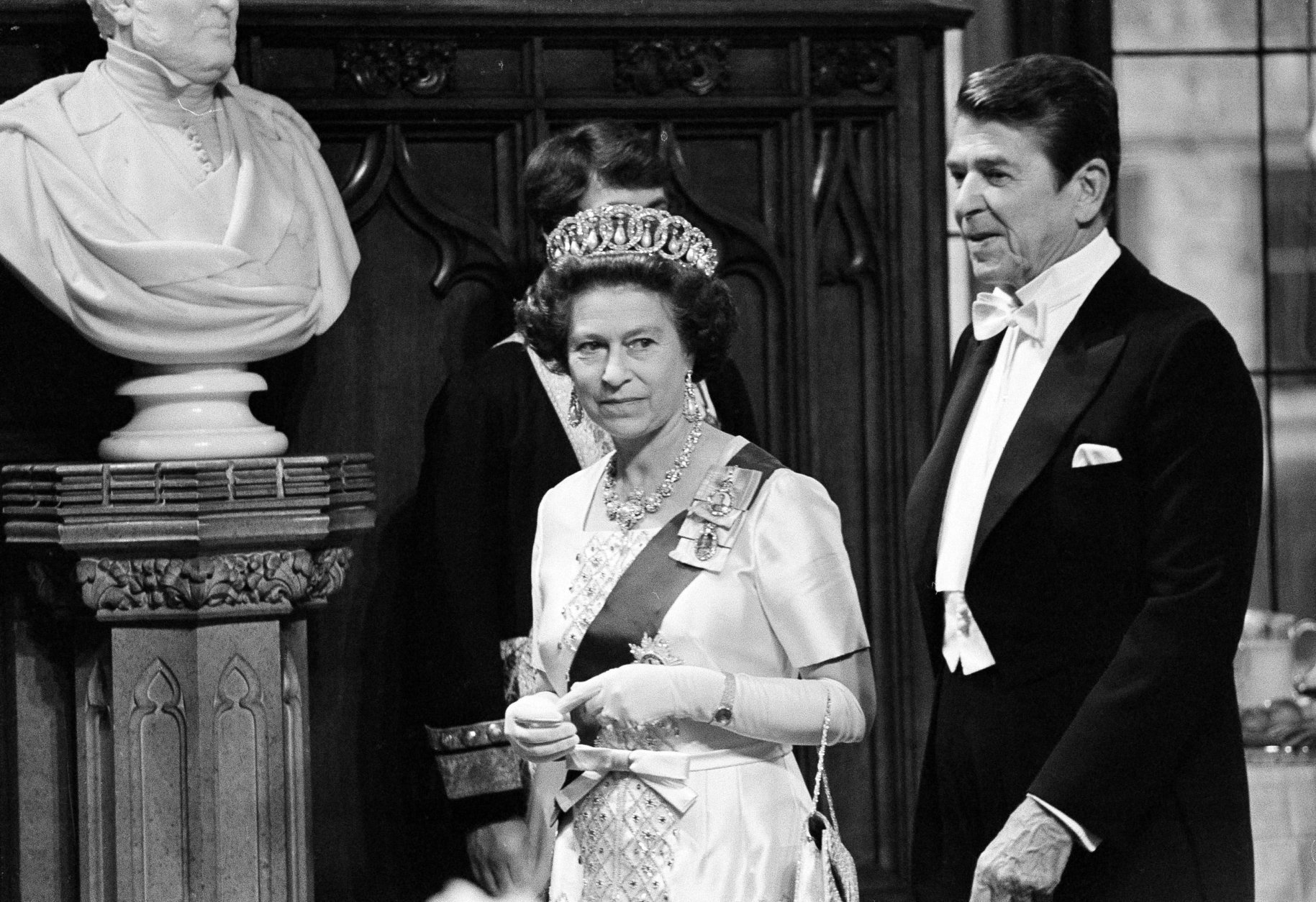 Queen Elizabeth II and President Ronald Reagan walk to the table in the St. George's Hall of Windsor Castle for dinner, June 8, 1980.  (AP Photo/Ira Schwarz)