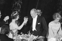 Pres. Gerald Ford, center, with wife Betty Ford by his side, right, toasts Queen Elizabeth II, left, following a State Dinner at the White House, July 7, 1975, Washington, D.C. Ford hosted the dinner under a canopy erected outside the South Portico of the Executive Mansion. (AP Photo/John Duricka)