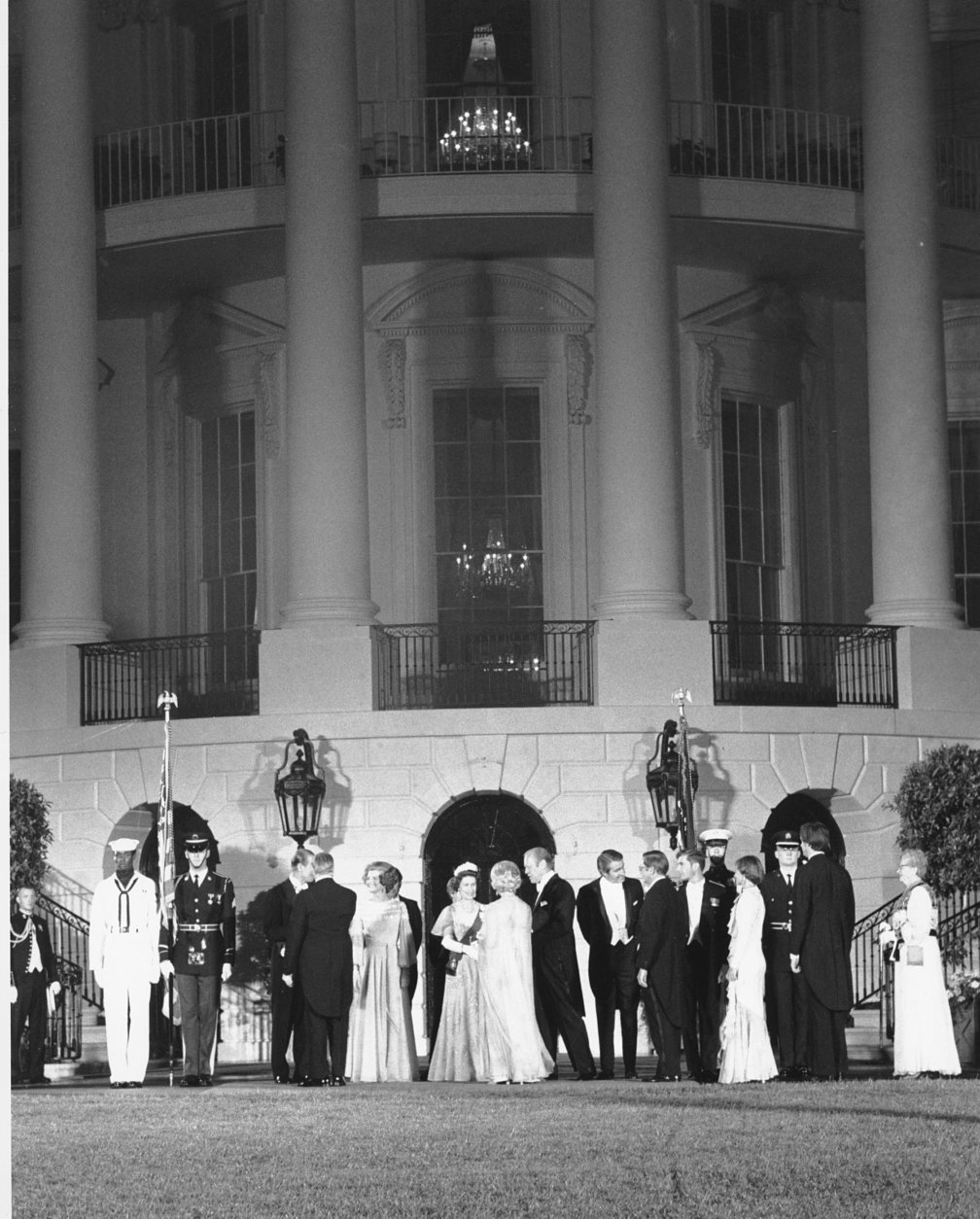 U.S. President Gerald Ford and first lady Betty Ford stand in a receiving line with Queen Elizabeth II and Prince Philip outside the South Portico of the White House in Washington, D.C., on July 7, 1976.  Following the garden reception is the state dinner in honor of the Queen of England.  In the background is the Truman balcony.  (AP Photo)