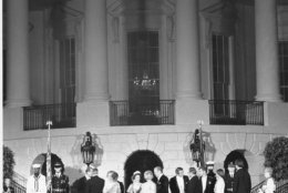 U.S. President Gerald Ford and first lady Betty Ford stand in a receiving line with Queen Elizabeth II and Prince Philip outside the South Portico of the White House in Washington, D.C., on July 7, 1976.  Following the garden reception is the state dinner in honor of the Queen of England.  In the background is the Truman balcony.  (AP Photo)