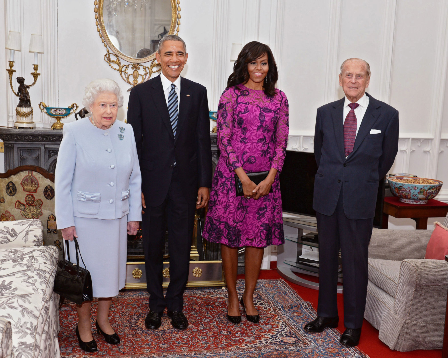 President Barack Obama, center left, and his wife first lady Michelle Obama, center right, pose with Britain's Queen Elizabeth II, left, and Prince Phillip in the Oak room at Windsor Castle ahead of a private lunch hosted by the Queen, Friday, April 22, 2016 (John Stillwell/Pool)