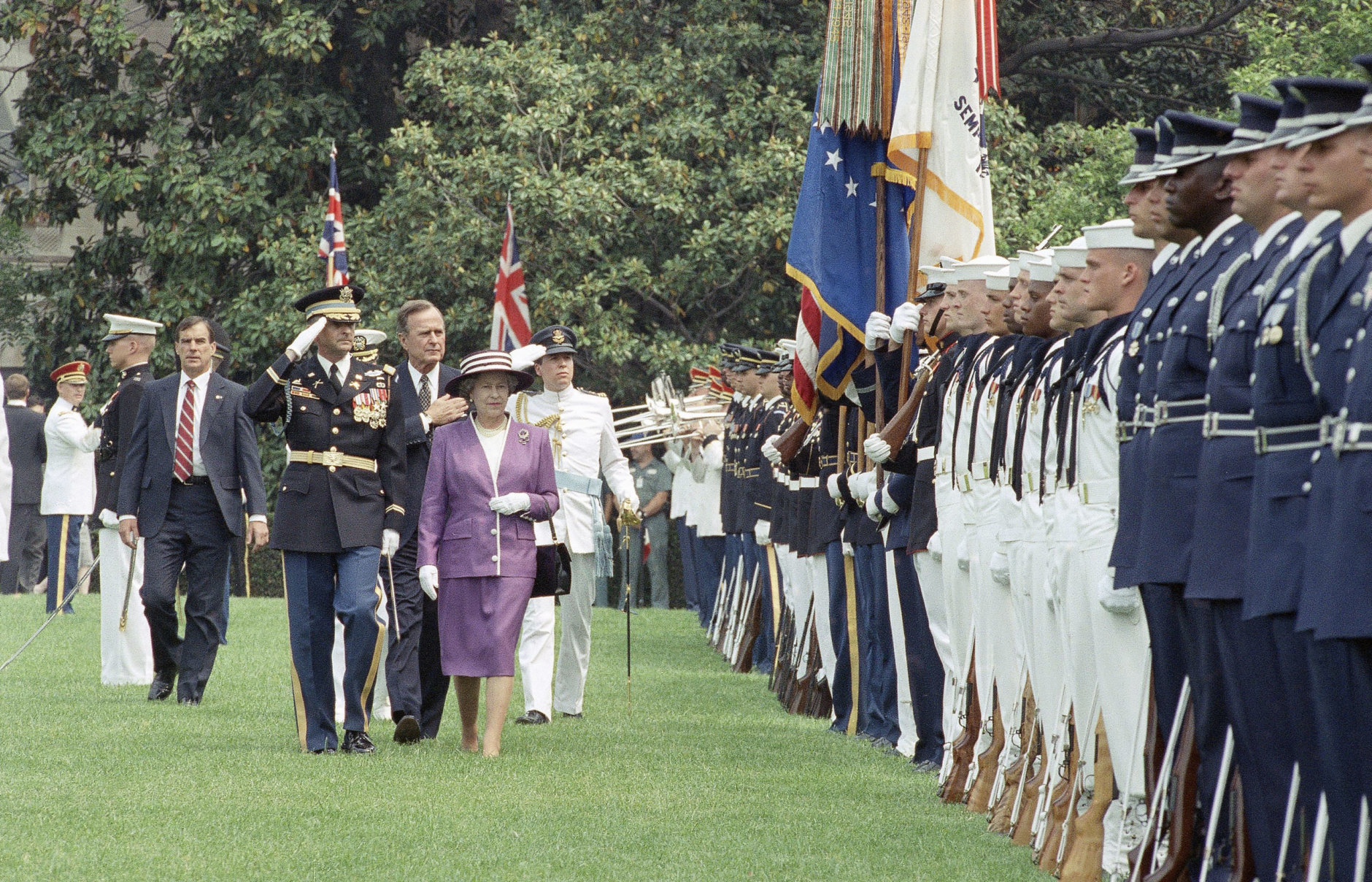 Queen Elizabeth II and President  George H.W. Bush,  along with Commander of Troops Col. Barrie Zais, left, review the troops after the Queen's arrival at the White House on Tuesday, May 14, 1991 in Washington.   The Queen is to spend four days in Washington. (AP Photo/Barry Thumma)