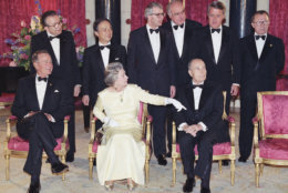 Queen Elizabeth II directs G-7 leaders for the photo session at Buckingham Palace in London, Tuesday, July 16, 1991. From left; President George Bush, Italy's Prime Minister Giulio Andreotti, Japan's Prime Minister Toshiki Kaifu, Britain's Prime Minister John Major, German Chancellor Helmut Kohl, France's President Francois Mitterrand, Canada's Prime Minister Brian Mulroney and EC President Jacques Delors. (AP Photo/Lionel Cironneau)