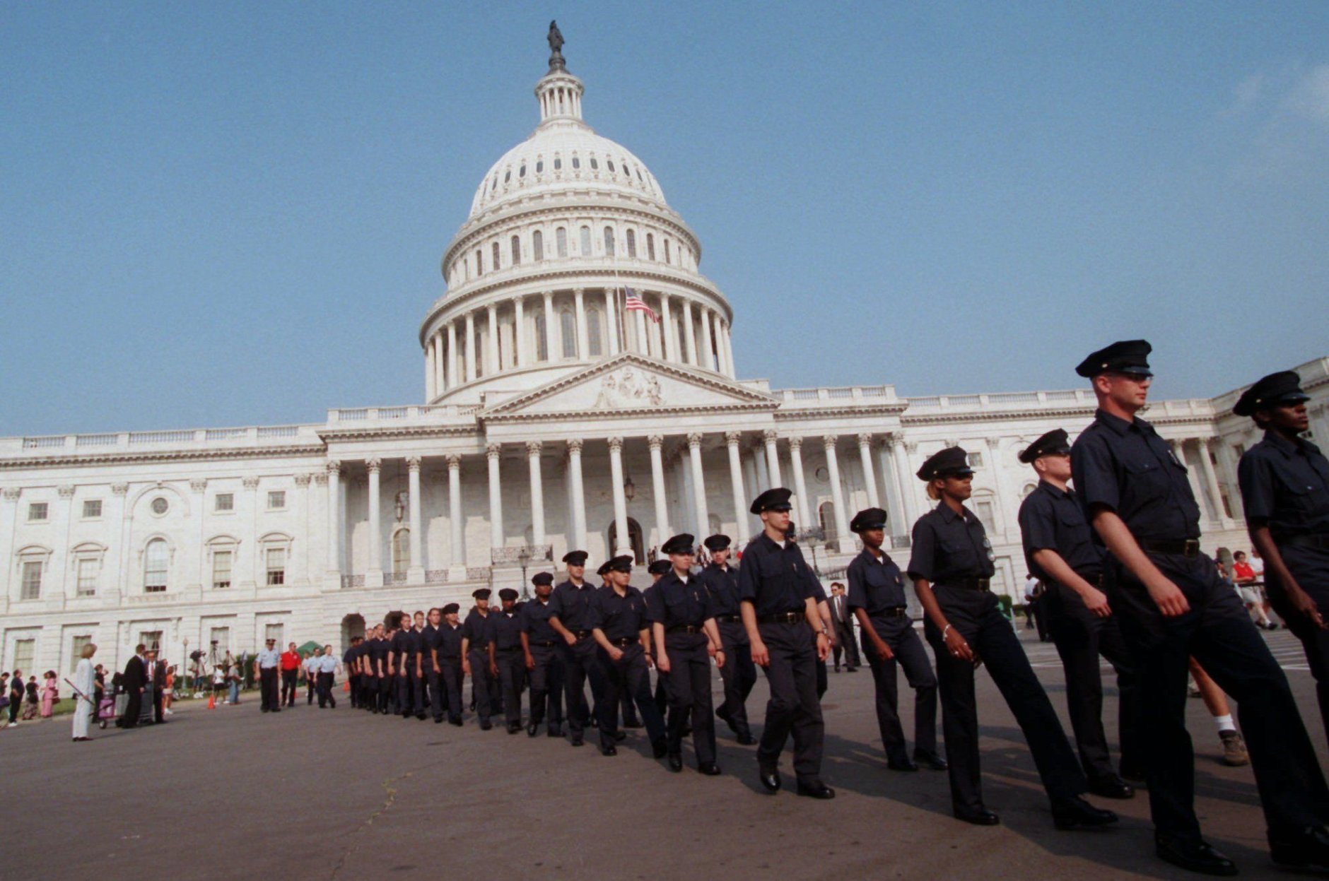 Capitol police officers march on Capitol Hill Tuesday, July 28, 1998 prior to a memorial service honoring two slain Capitol police officers. In exceptional homage, members of the public filed noiselessly into the stately Rotunda and around the flag-draped caskets of the two officers who were slain defending the building Friday. (AP Photo/Khue Bui)