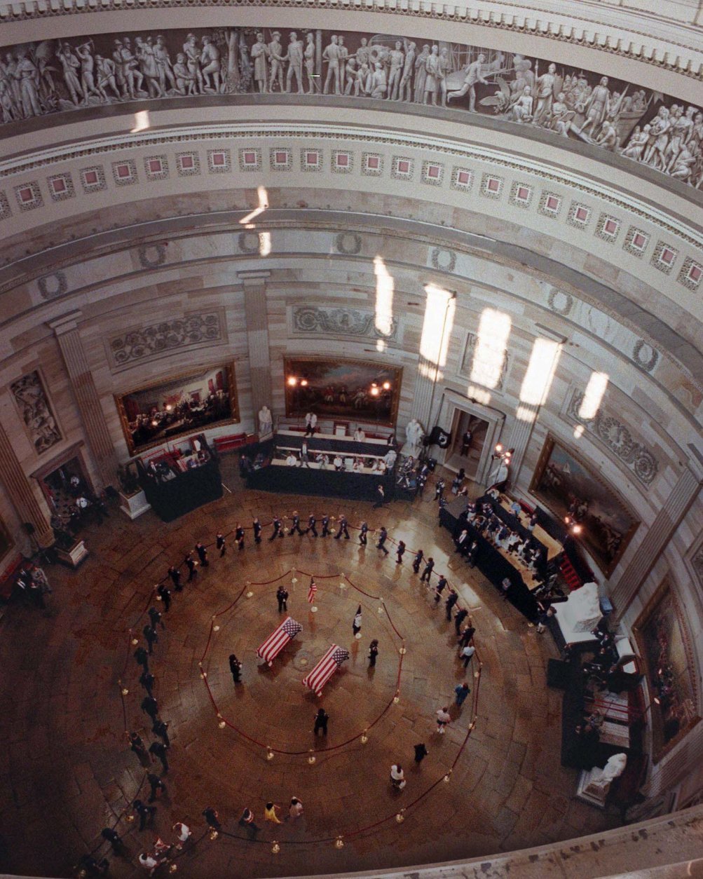 The view of the Capitol Rotunda Tuesday, July 28, 1998 where the bodies of Capitol Police Officers Jacob Chestnut, left, and John Gibson lie in honor. In exceptional homage, members of the public filed noiselessly into the stately Rotunda and around the flag-draped caskets of the two officers who were slain defending the building Friday. (AP Photo/Joe Marquette/Pool)