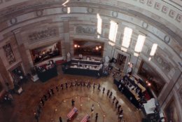 The view of the Capitol Rotunda Tuesday, July 28, 1998 where the bodies of Capitol Police Officers Jacob Chestnut, left, and John Gibson lie in honor. In exceptional homage, members of the public filed noiselessly into the stately Rotunda and around the flag-draped caskets of the two officers who were slain defending the building Friday. (AP Photo/Joe Marquette/Pool)