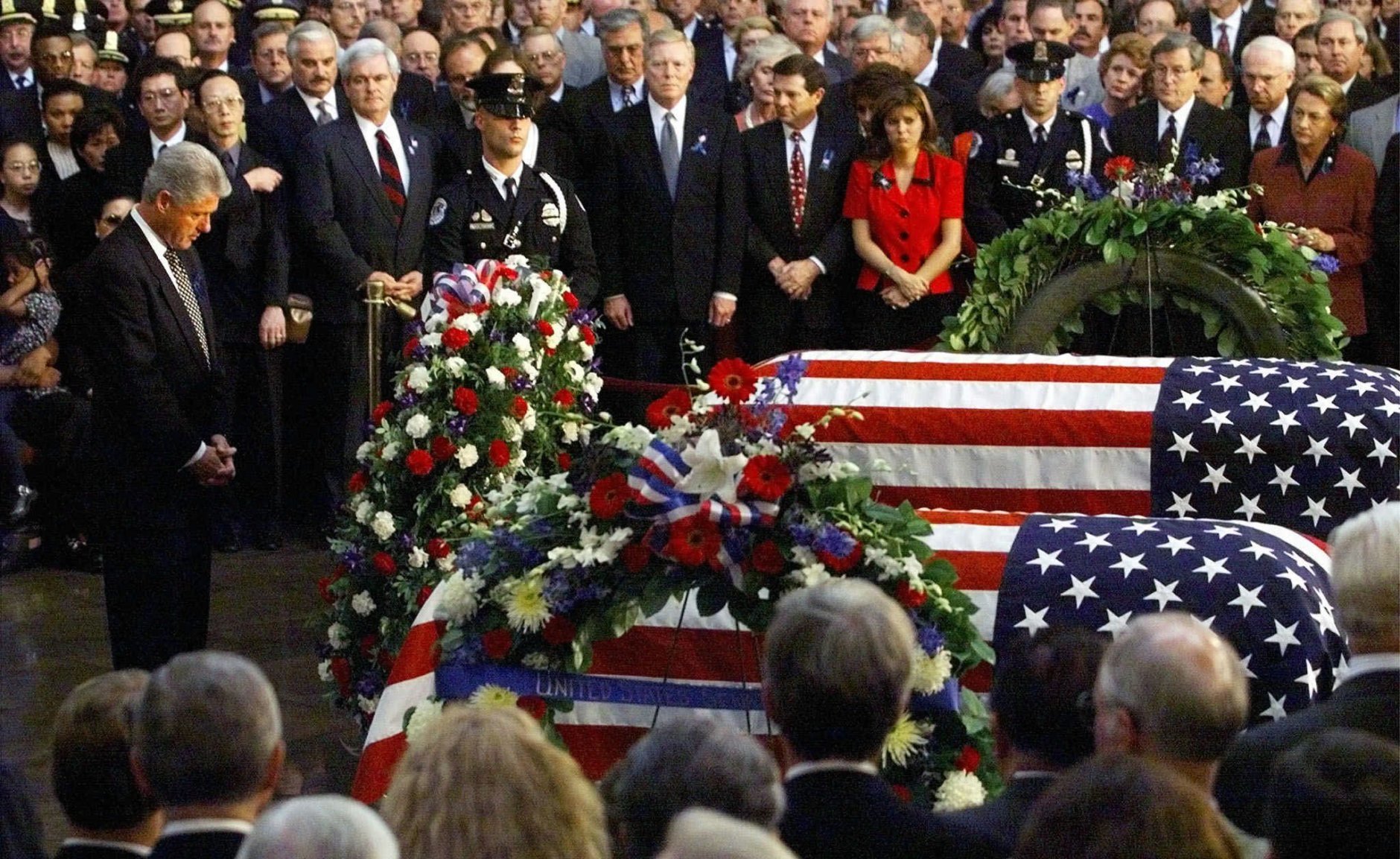 President Clinton pauses after laying a wreath at the caskets of Capitol officers Jacob J. Chestnut and John Gibson during a Congressional tribute at the Capitol Rotunda Tuesday, July 28, 1998, in Washington. (AP Photo/Win McNamee, Pool)