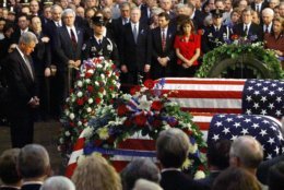 President Clinton pauses after laying a wreath at the caskets of Capitol officers Jacob J. Chestnut and John Gibson during a Congressional tribute at the Capitol Rotunda Tuesday, July 28, 1998, in Washington. (AP Photo/Win McNamee, Pool)
