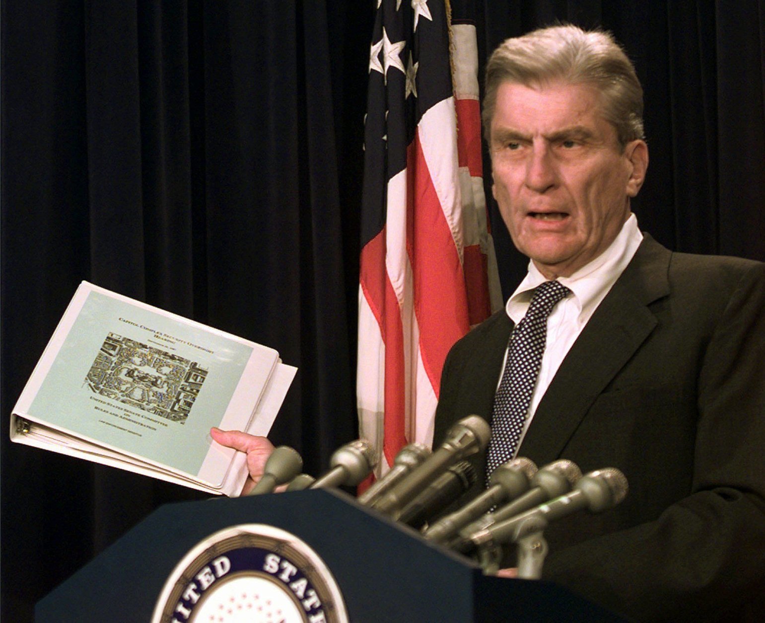 Senate Rules Committee Chairman Sen. John Warner, R-Va. holds the classified Senate Oversight Security plan during a Capitol Hill news conference Wednesday July 29, 1998 to discuss Capitol Security measures. Warner's committee oversees activities on the Capitol grounds. Republican leaders would like to push legislation through Congress this year for a new Capitol visitors center, after two fallen police officers who died protecting the building. (AP Photo/Joe Marquette)