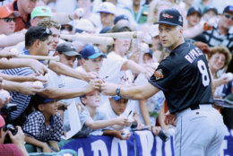 DENVER - JULY 7:  Cal Ripken Jr. of the American League signs autographs for fans during the MLB All-Star Game at Coors Field on July 7, 1998 in Denver, Colorado.  The American League defeated the National League 13-8.  (Photo by: Jed Jacobsohn/Getty Images)