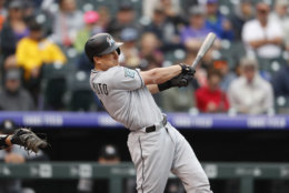 Miami Marlins catcher J.T. Realmuto (11) in the first inning of a baseball game Sunday, June 24, 2018, in Denver. (AP Photo/David Zalubowski)