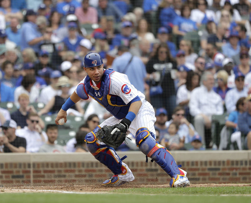 Chicago Cubs catcher Willson Contreras checks the runner at first during the sixth inning of a baseball game against the Los Angeles Dodgers Wednesday, June 20, 2018, in Chicago. (AP Photo/Charles Rex Arbogast)