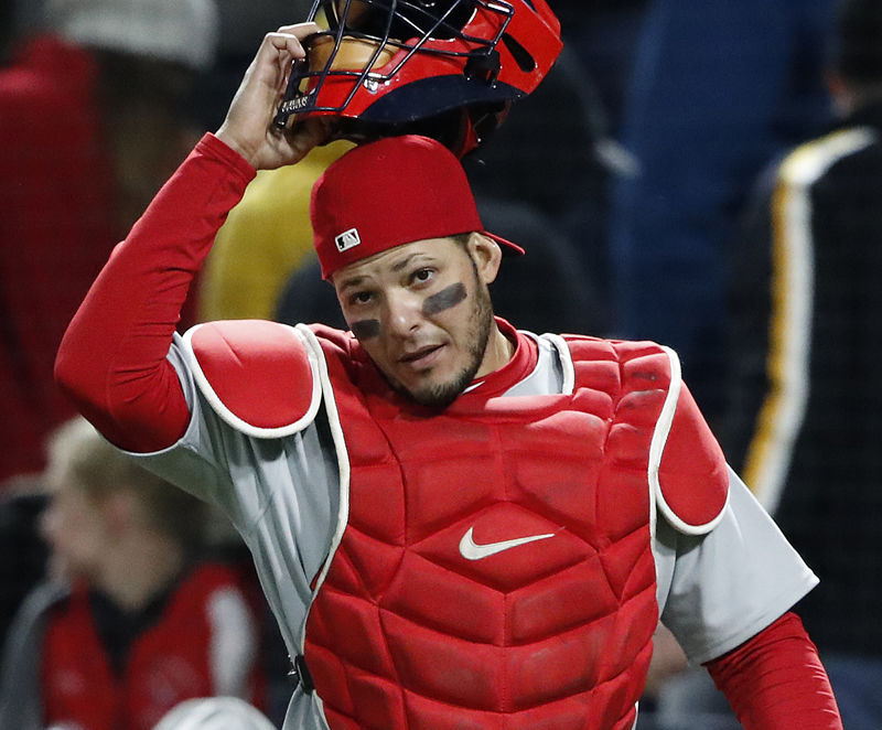 St. Louis Cardinals catcher Yadier Molina puts on his mask after chasing a foul ball during a baseball game against the Pittsburgh Pirates in Pittsburgh, Saturday, April 28, 2018. (AP Photo/Gene J. Puskar)