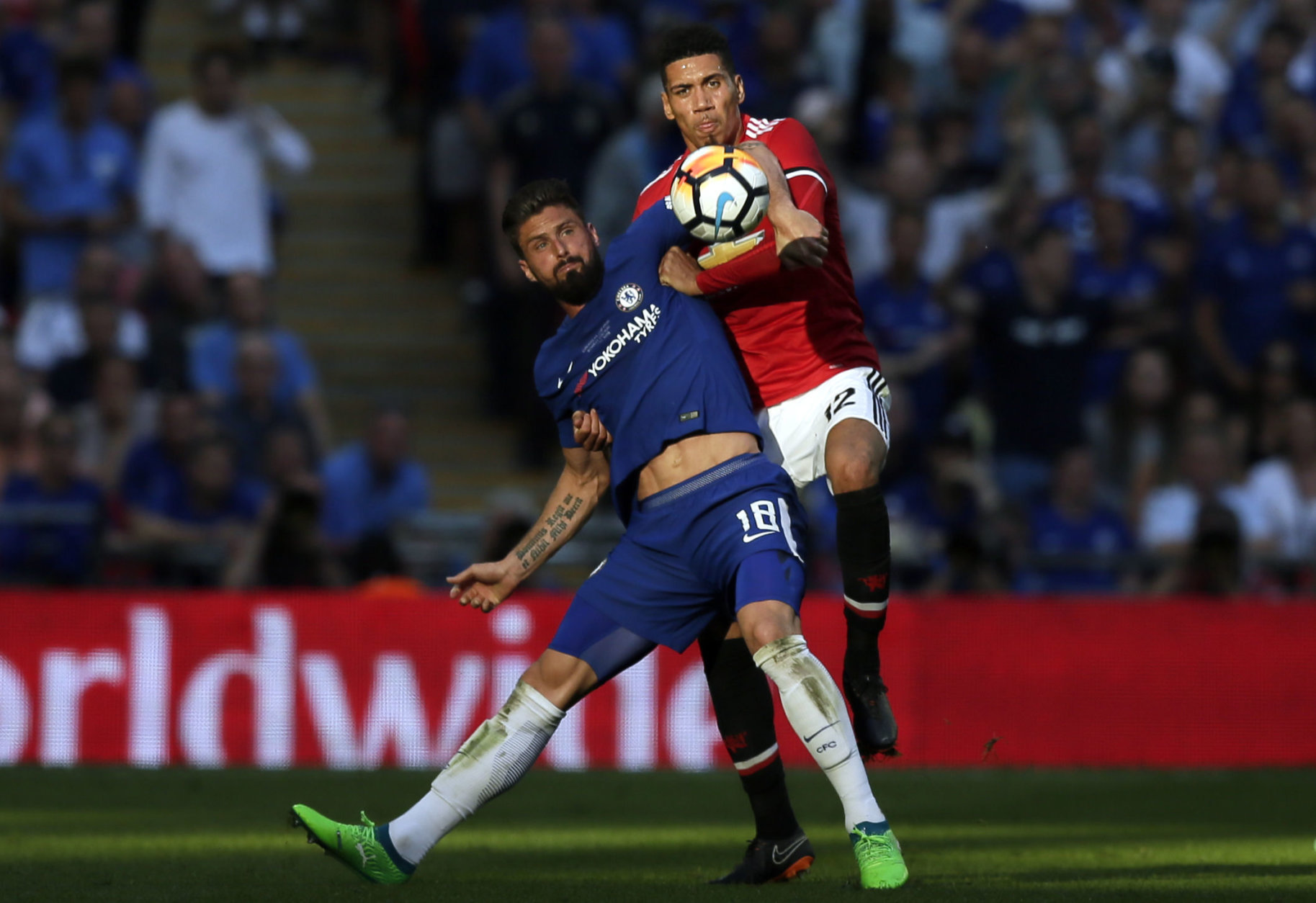 Chelsea's Olivier Giroud fights for the ball with Manchester United's Chris Smalling, right, during the English FA Cup final soccer match between Chelsea and Manchester United at Wembley stadium in London, Saturday, May 19, 2018. (AP Photo/Tim Ireland)