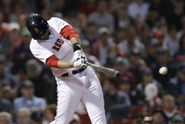 Boston Red Sox's J.D. Martinez takes a swing during the seventh inning of a baseball game at Fenway Park in Boston, Wednesday, June 27, 2018. (AP Photo/Charles Krupa)