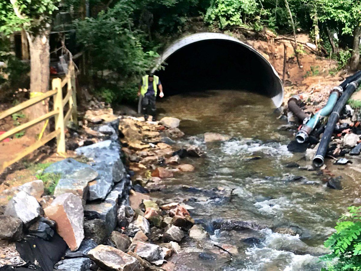 After the recent heavy rain, a worker in Ellicott City makes sure the culvert carrying the canal through downtown is clear of debris. (WTOP/Neal Augenstein) 