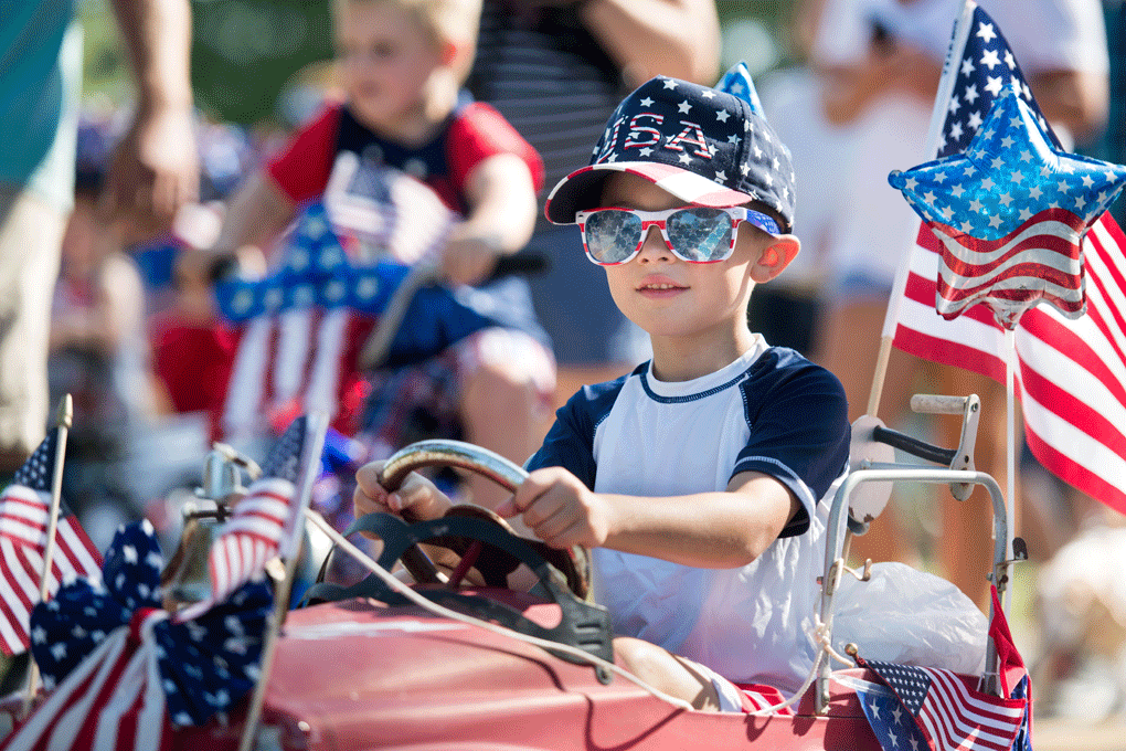 A young boy rides a toy firetruck during the sixteenth annual Harper Street Parade on July 4, 2018 in Newberry, South Carolina. The event, beginning as a small bicycle gathering with less than thirty children, attracted 4,000 people last year. (Photo by Sean Rayford/Getty Images)