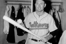 George Kell, Baltimore Orioles, poses in dressing room with ball and bat after rapping out three hits - one a homer - to gain his 2,000th hit June 5, 1957.  (AP stf)