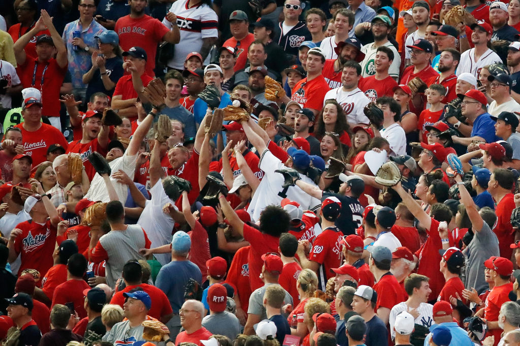 WASHINGTON, DC - JULY 16: Fans try to catch a home run hits a by Rhys Hoskins of the Philadelphia Phillies and the National League during the T-Mobile Home Run Derby at Nationals Park on July 16, 2018 in Washington, DC.  (Photo by Patrick McDermott/Getty Images)