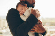 Newborn baby boy in his father's arms