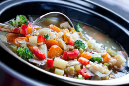Vegetable soup, slow-cooked in a crock pot, ready to serve.