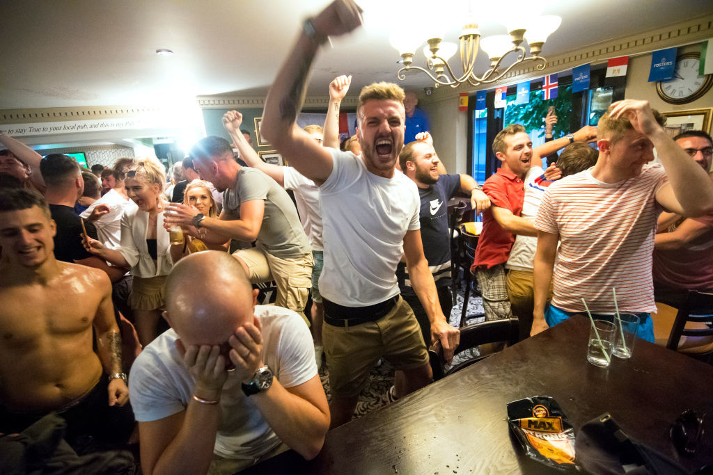 MANCHESTER, ENGLAND - JULY 03:  Fans celebrate as England win on penalties during the FIFA 2018 World Cup Finals match between Colombia and England at The Lord Stamford public house in Manchester on July 3, 2018 in London, England. World Cup fever is building among England fans after reaching the Round of 16 in Russia.  (Photo by Anthony Devlin/Getty Images)