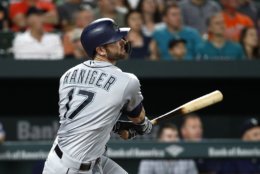 Seattle Mariners' Mitch Haniger hits a sacrifice fly ball in the seventh inning of a baseball game against the Baltimore Orioles, Monday, June 25, 2018, in Baltimore. Dee Gordon scored on the play. (AP Photo/Patrick Semansky)