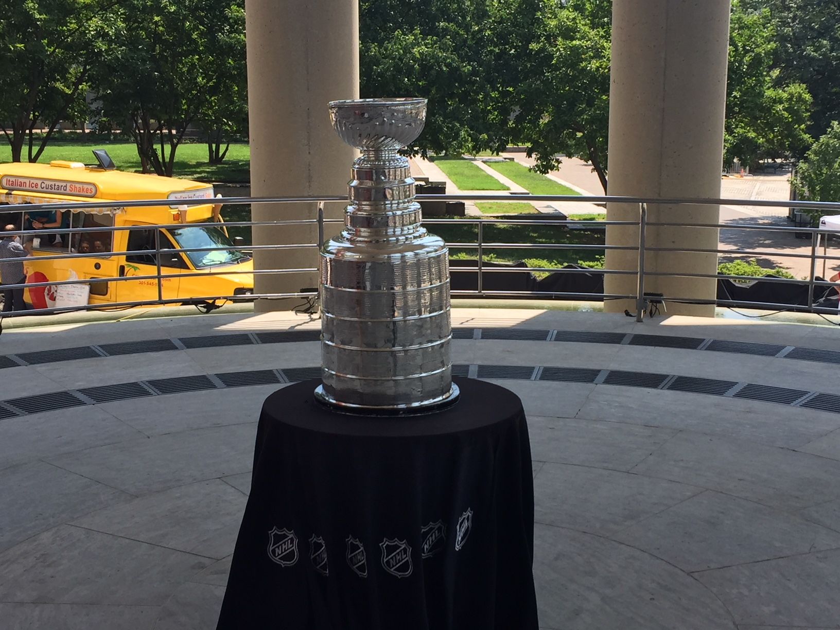 The line was long through the courtyard of the Canadian embassy Sunday, where people wearing different colored Canadian maple leafs with CFL jerseys celebrated Canada Day. The star of the show? The Stanley Cup. (WTOP/John Domen)