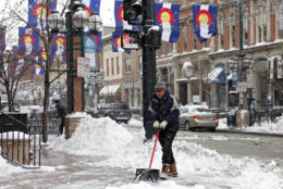 Workers clear the sidewalk on Larimer Square in downtown Denver on Friday, Feb. 3, 2012, after a snow storm hit Denver with 10 inches of snow overnight.   A powerful winter storm swept across Colorado on Friday as it headed east, bringing blizzard warnings to eastern Colorado and western Kansas, and winter storm warnings for southeast Wyoming and western Nebraska.  (AP Photo/Ed Andrieski)