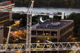 Photo by Dan Gross 
Crescent Moon art installation on a construction crane at the JBG Central Place project. The moon is illuminated at night by LED lights. Tuesday September 15, 2015.