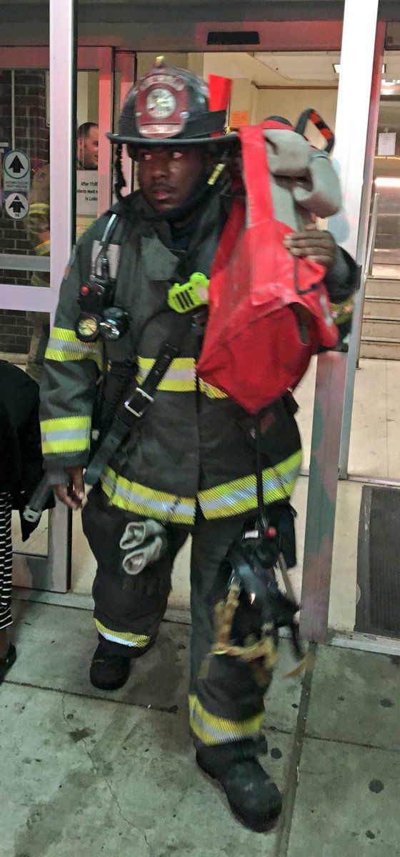 A firefighter leaves the scene of a fire at 1200 M Street Northwest near downtown D.C. One man was taken to the hospital in critical conditon but no other injuries were reported. (Courtesy D.C. Fire and EMS via Twitter)