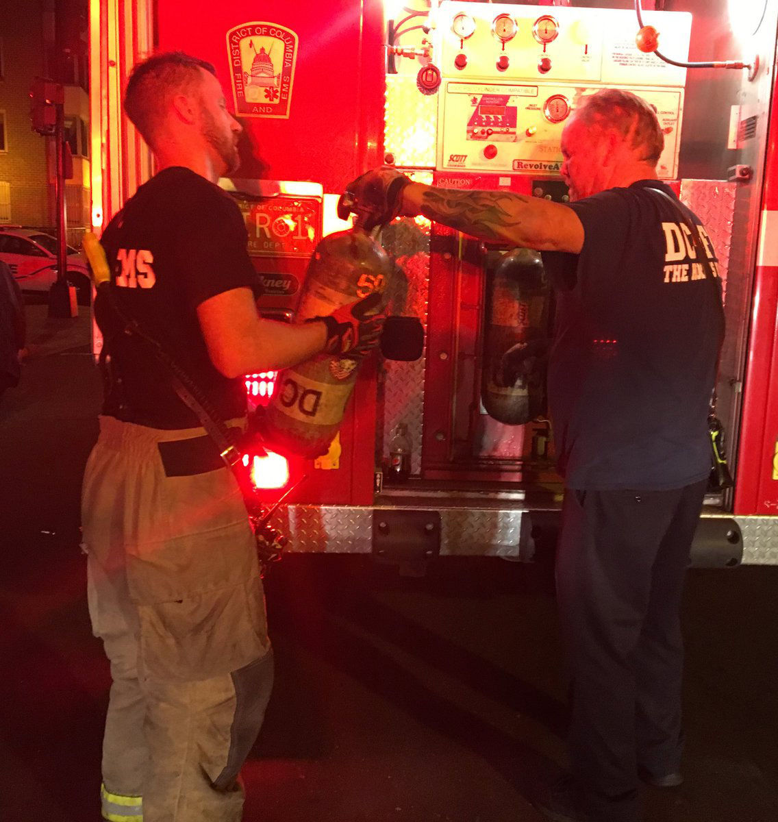 Firefighters filling their air bottles on the scene of a fire on M Street Northwest near downtown D.C. Saturday morning. Investigators are still on scene working to determine the cause of the fire. (Courtesy D.C. Fire and EMS via Twitter)