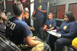 Firefighters resting after putting out the fire on M Street Northwest near downtown D.C. early Saturday morning. (Courtesy D.C. Fire and EMS via Twitter)