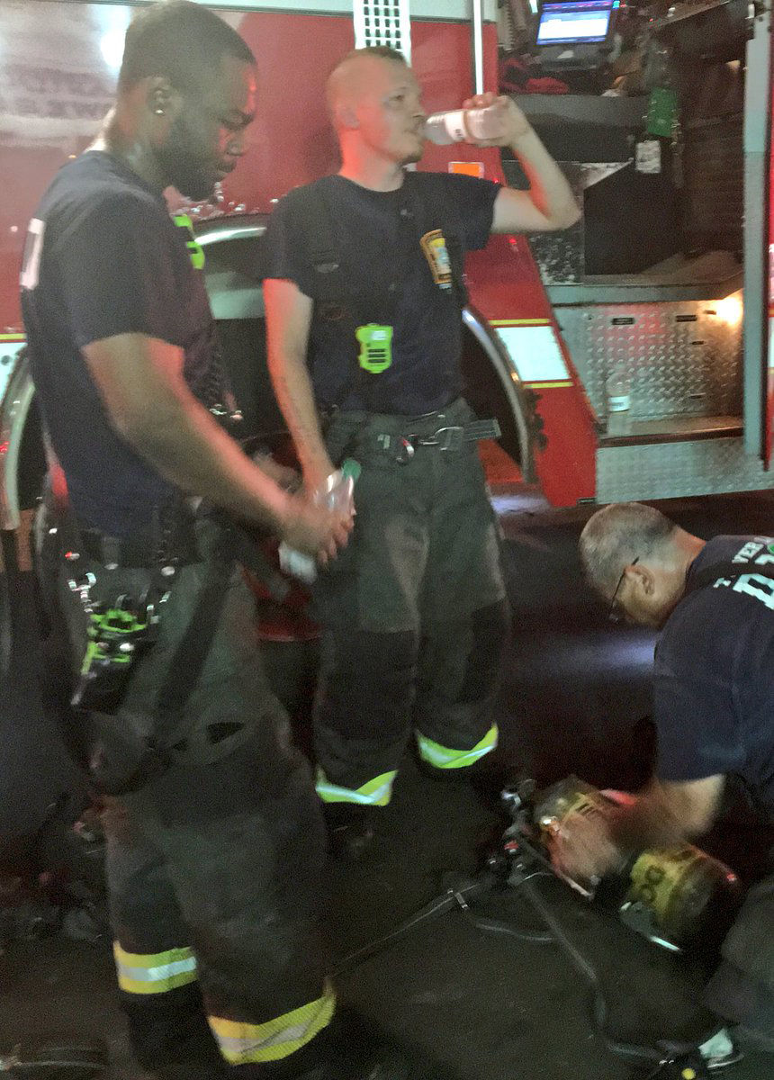 Firefighters rehydrate for their next call while still on the scene of a fire on M Street Northwest near downtown D.C. (Courtesy D.C. Fire and EMS via Twitter)