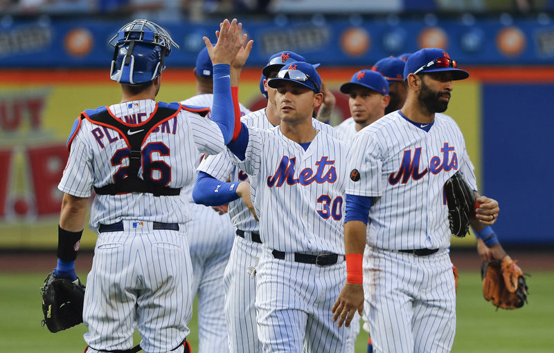 New York Mets' Michael Conforto (30) celebrates with teammates after the Mets beat the Washington Nationals 7-4 in a baseball game, Saturday, July 14, 2018, in New York. (AP Photo/Julie Jacobson)