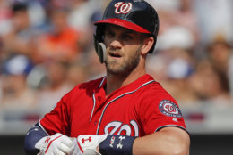 Washington Nationals' Bryce Harper pulls off his batting gloves after striking out to end the top of the first inning of a baseball game against the New York Mets, Saturday, July 14, 2018, in New York. The Mets won 7-4. (AP Photo/Julie Jacobson)