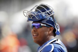 Kansas City Royals catcher Salvador Perez gets ready for a pitch during the first inning of a spring training baseball game against the Cincinnati Reds, Wednesday, Feb. 28, 2018, in Surprise, Ariz. (AP Photo/Charlie Neibergall)