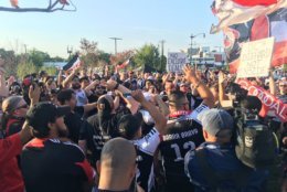 Members of La Barra Brava and District Ultras supporters groups protest outside the stadium before the game. (WTOP/Noah Frank)
