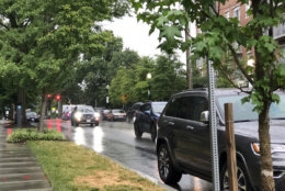 Cars drive down Idaho Avenue NW in the rain in D.C. on Tuesday, July 24. The weather has caused a lot of problems on local roads. (WTOP/Patrick Roth)